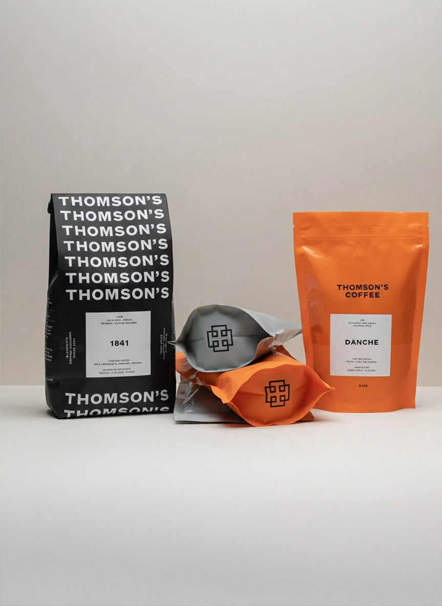 Two coffee packages from Thomson's Coffee on a white background