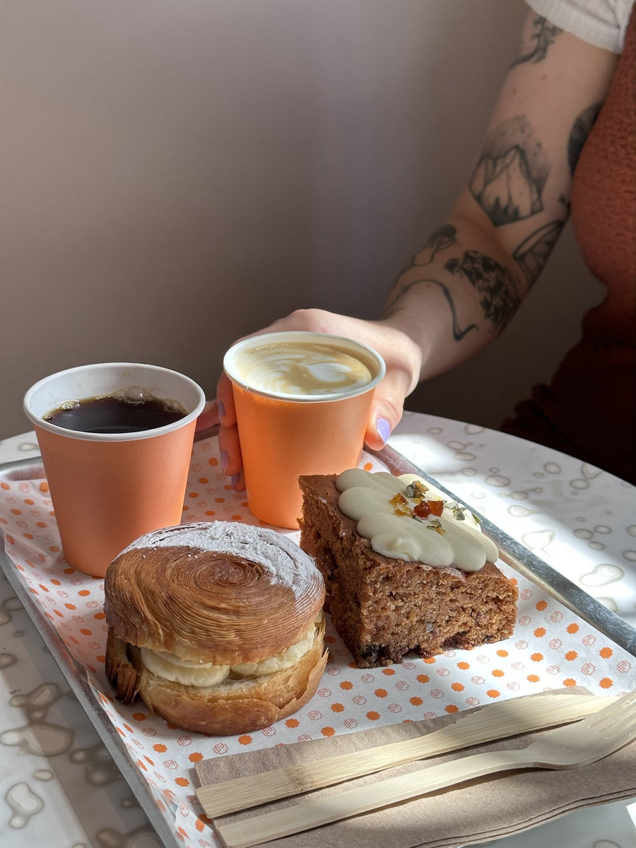 Coffees with pastries on a tray at a bakery café serving Thomson's coffee