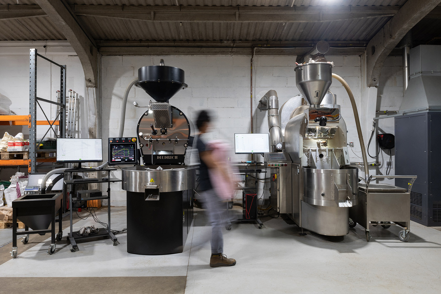 coffee roasters with person walking past carrying sack of coffee