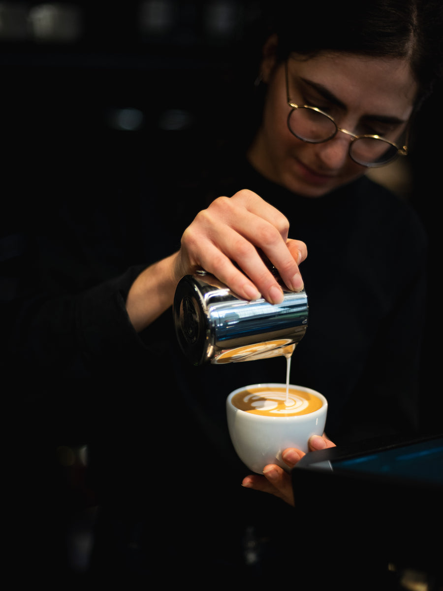 Barista pouring latte art