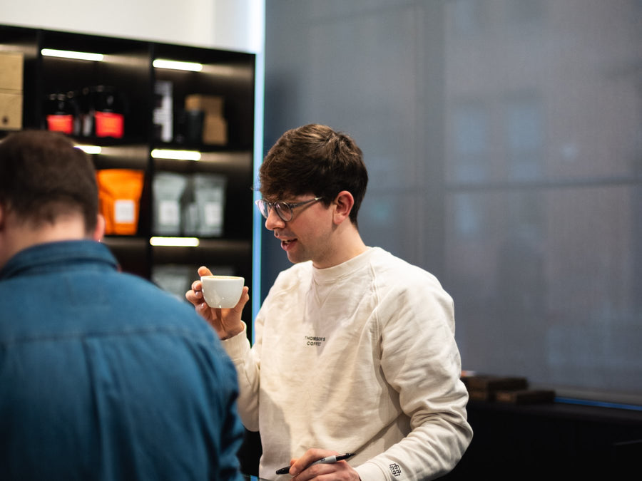 Barista chatting with a customer over a coffee
